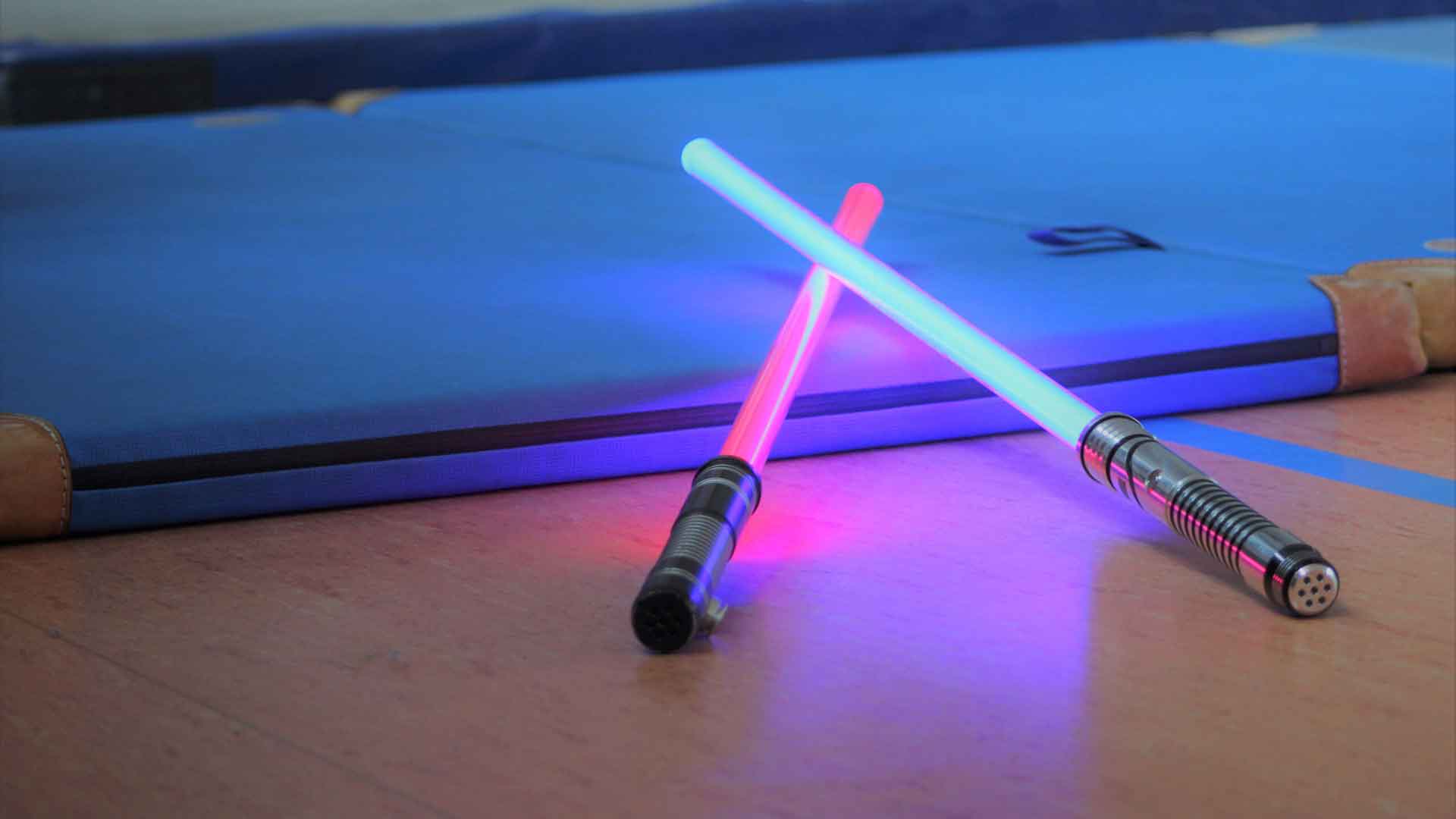 Two lightsabers lay side by side