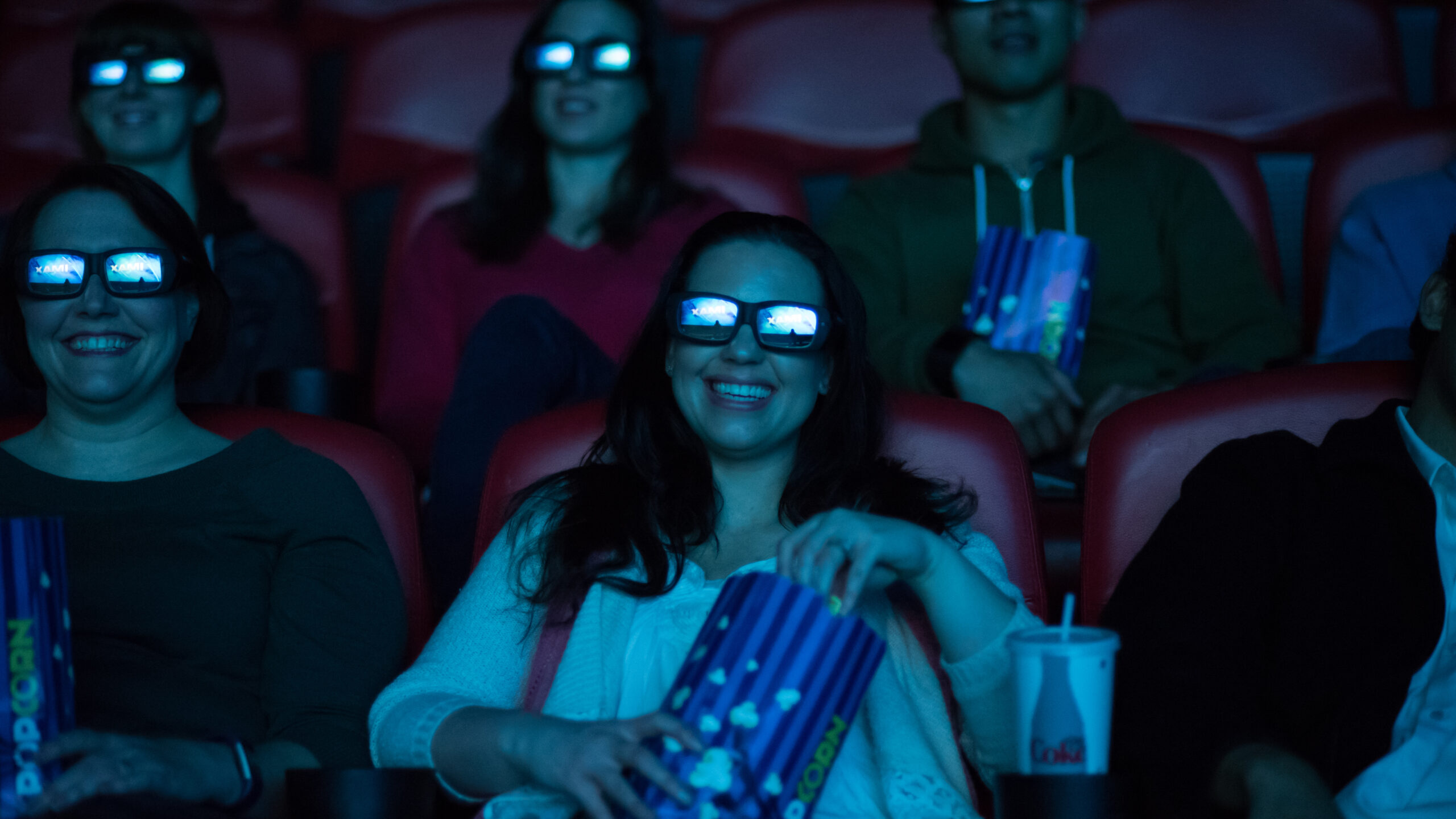 People wearing 3D glasses in a theater