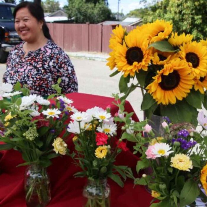 Woman selling flowers at a farmer's market