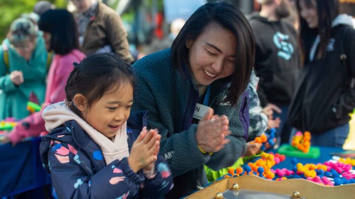 child and woman at an engineering exhibit