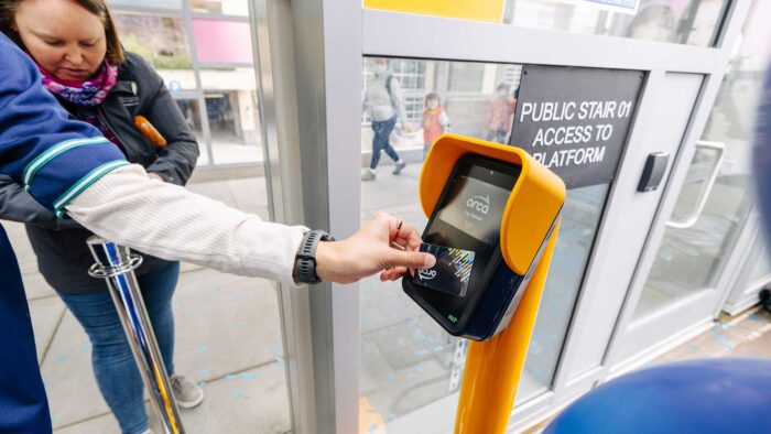 Person tapping Orca Card at the light rail station