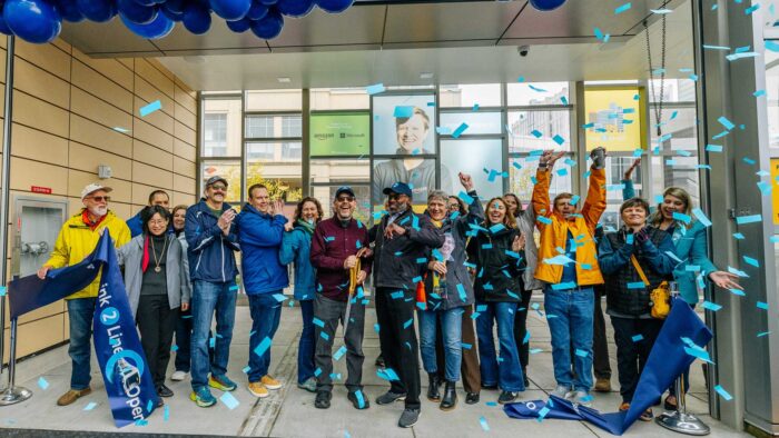 People at a ribbon cutting event for the Link Lightrail Line 2 opening