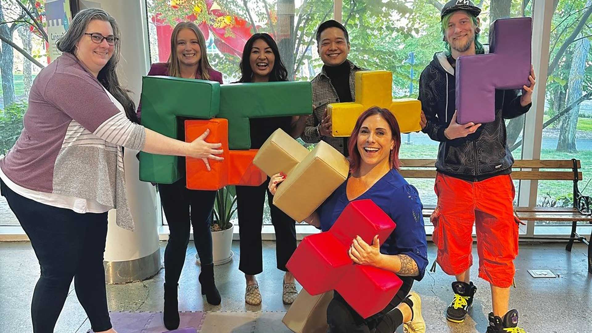 Adults playing with large building blocks