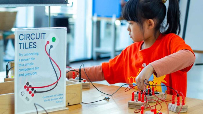 Camper in Tinker Tank working a circuit board