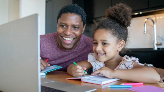 Father and daughter looking at a computer