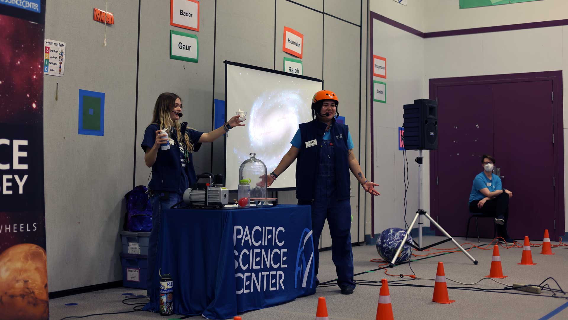 Two Science on Wheels educators presenting in front of an auditorium