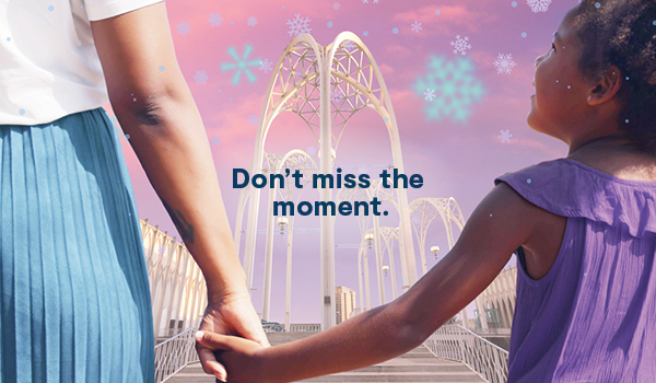 Don't miss the moment. Woman and child holding hands under the PacSci Arches.