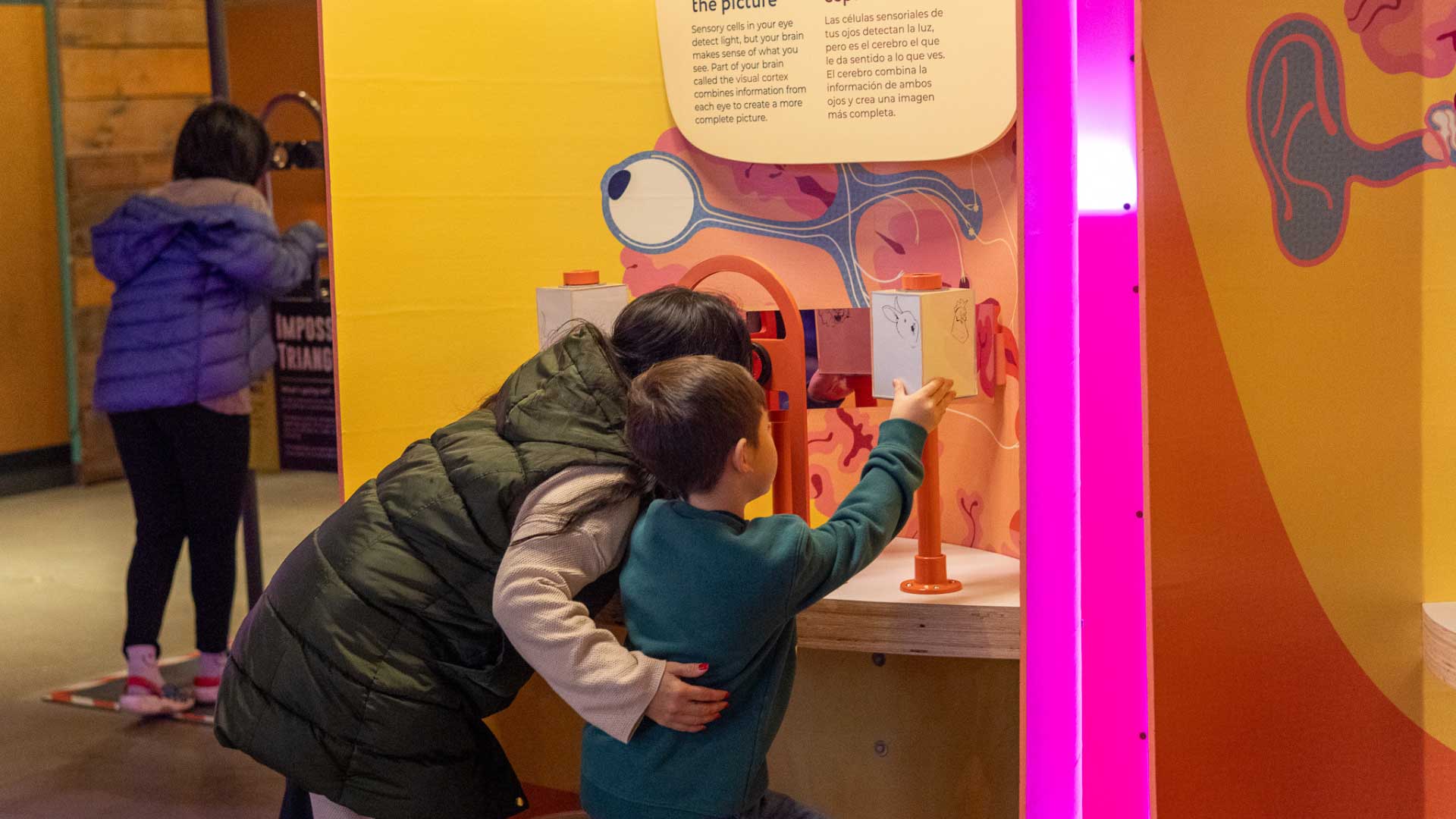 Mom and child in Brainy Bodies exhibit