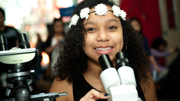 A child looking in to a microscope